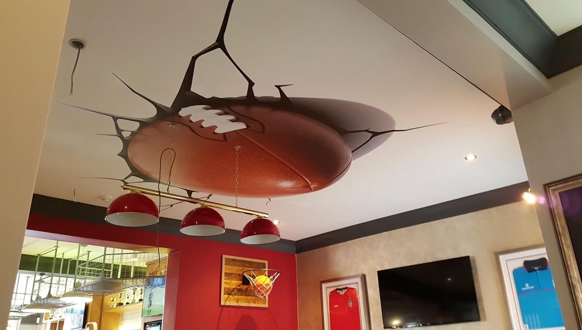 Rugby ball ceiling burst mural