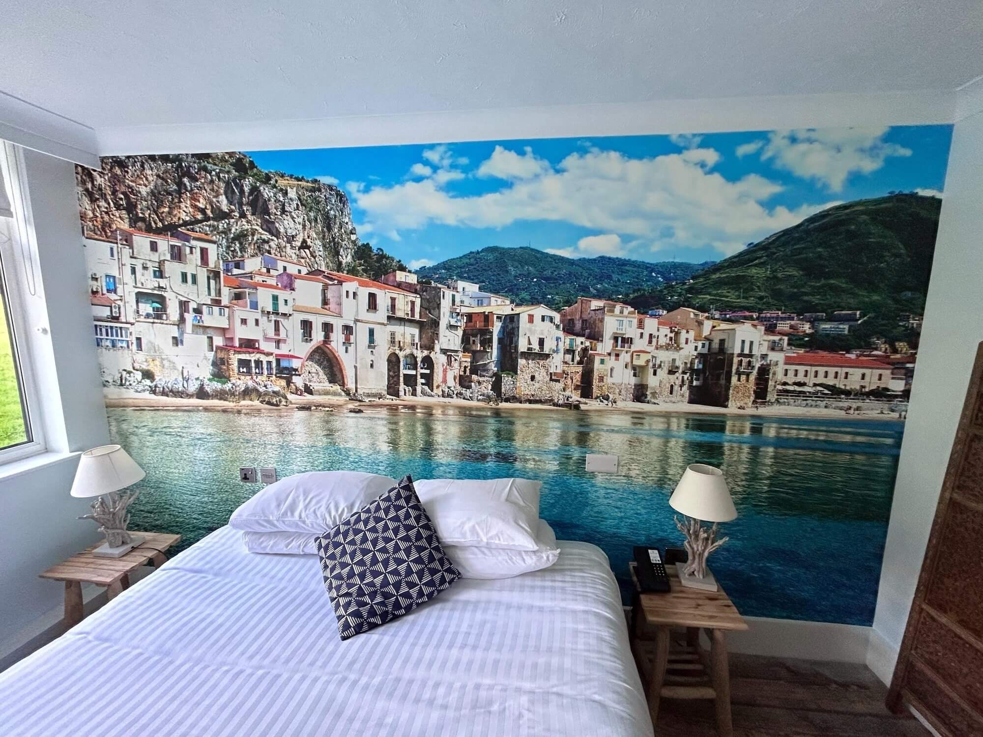 Sicilian coastal town hotel bedroom mural